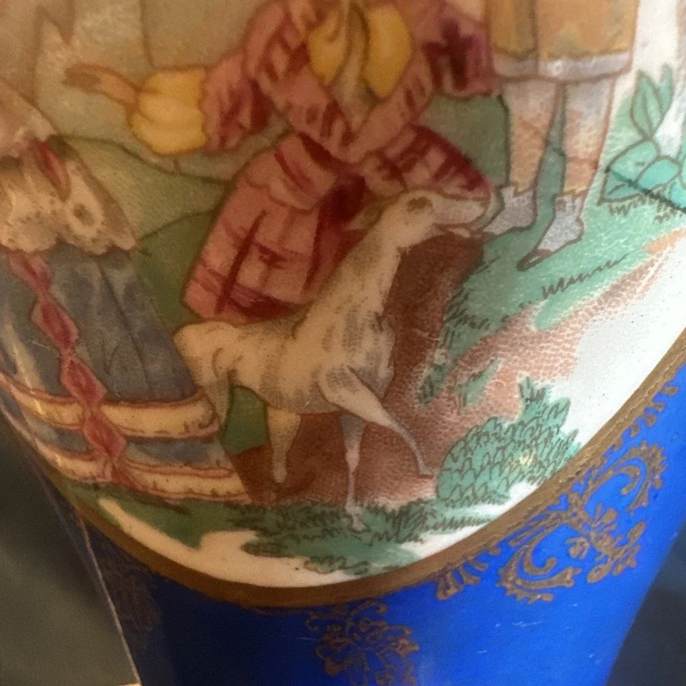 Antique porcelain urn lamp with grape-picking scene.